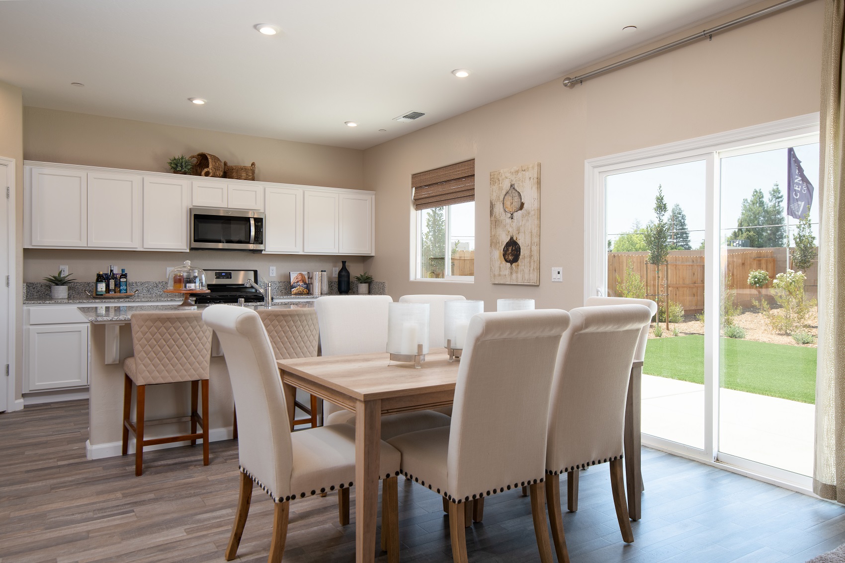A kitchen with a dining table and white cabinets.
