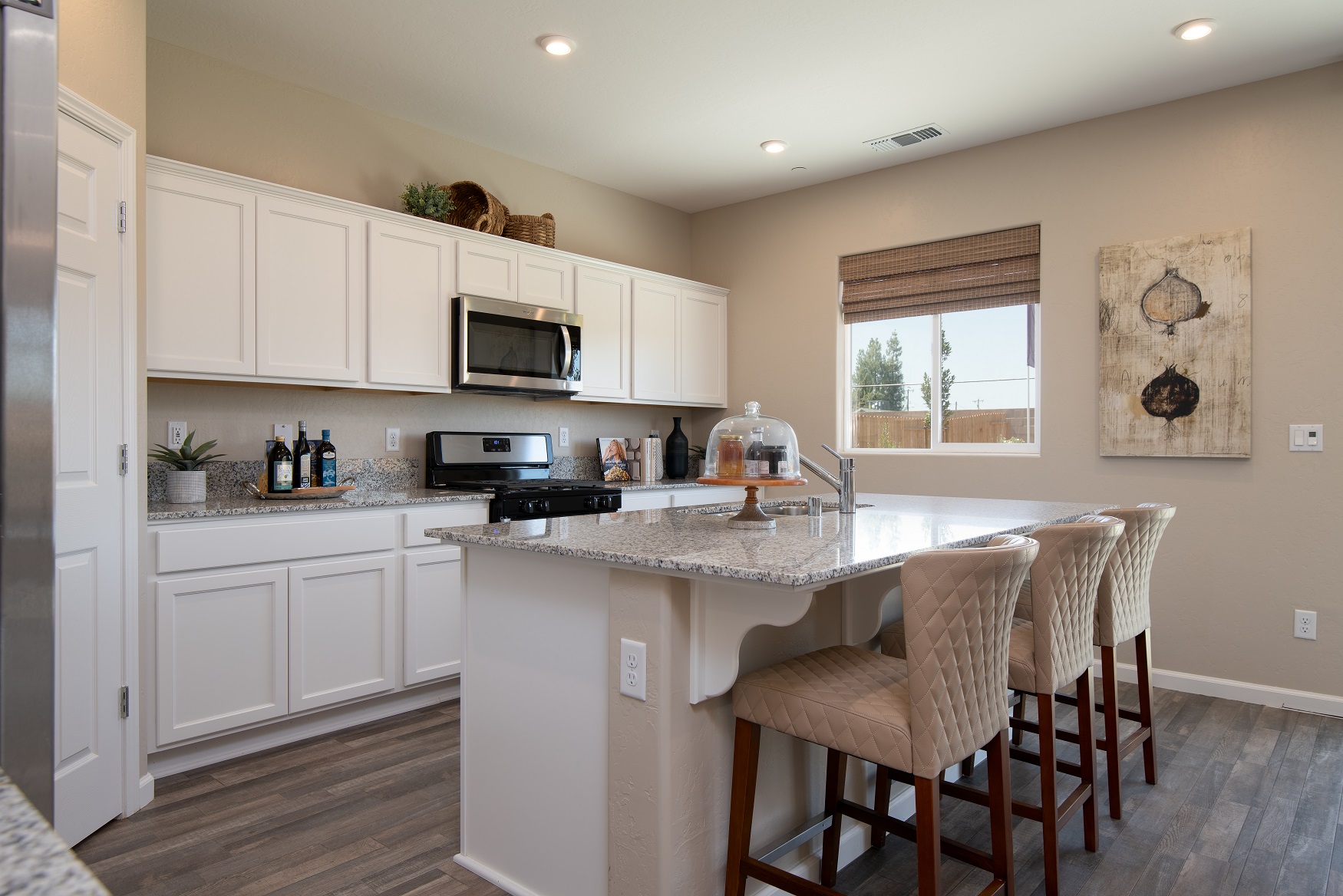 A kitchen with white cabinets.