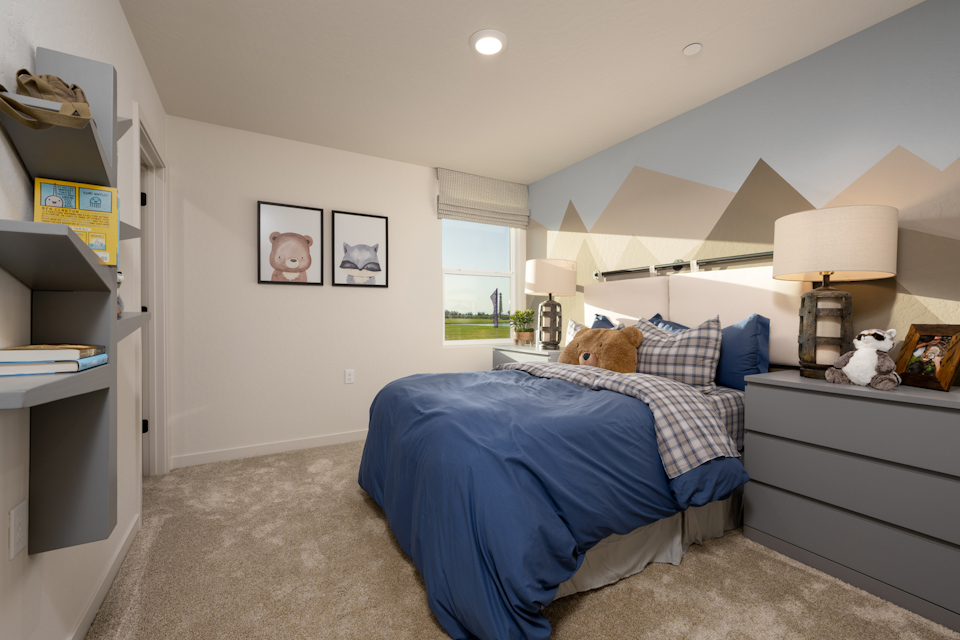 A bedroom with a bed and a lamp.