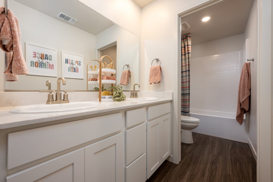 A bathroom with a sink toilet and a shower.