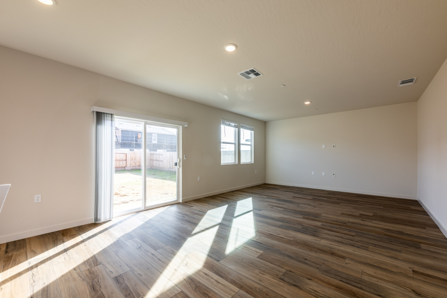 A room with a wood floor and a glass door.