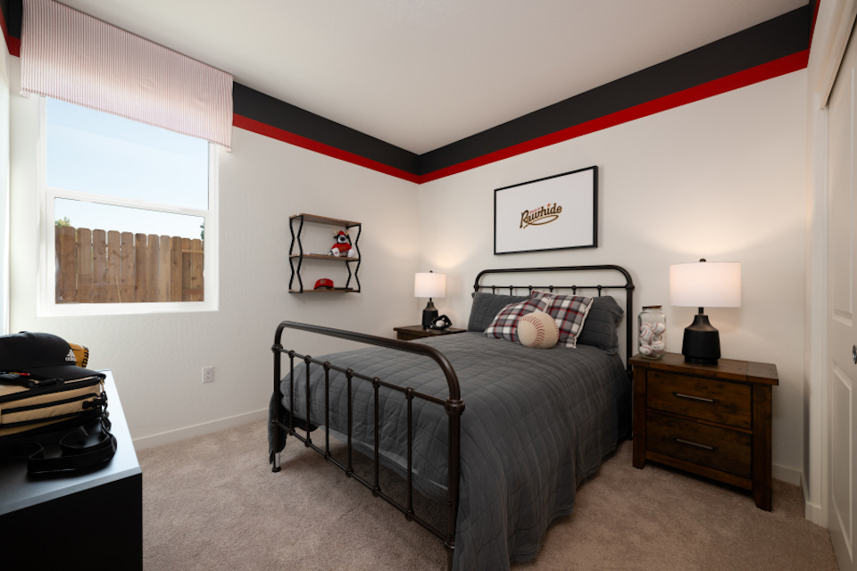 A bedroom with a bed and lamps.