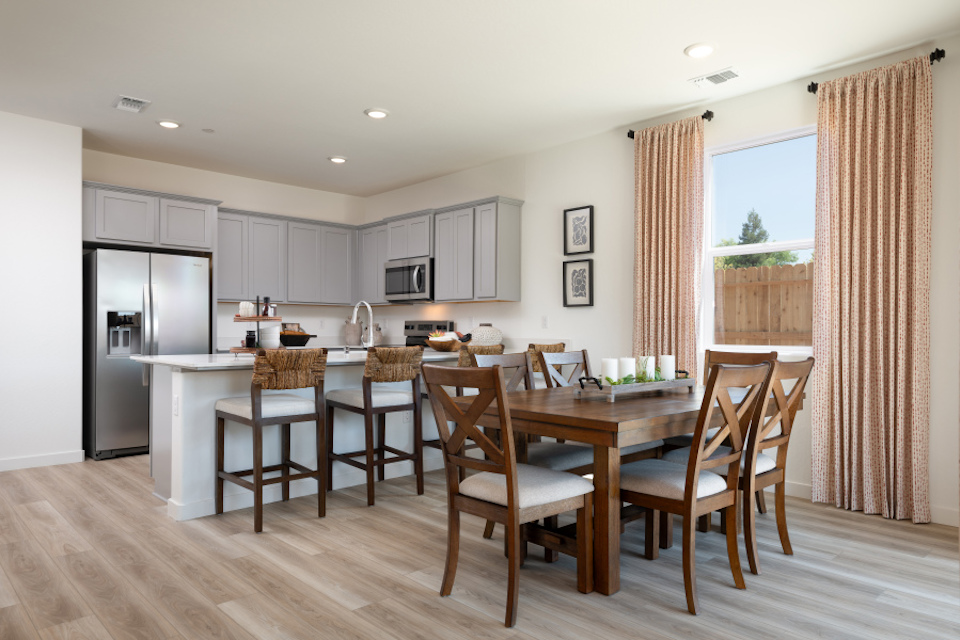 A kitchen with a dining table.
