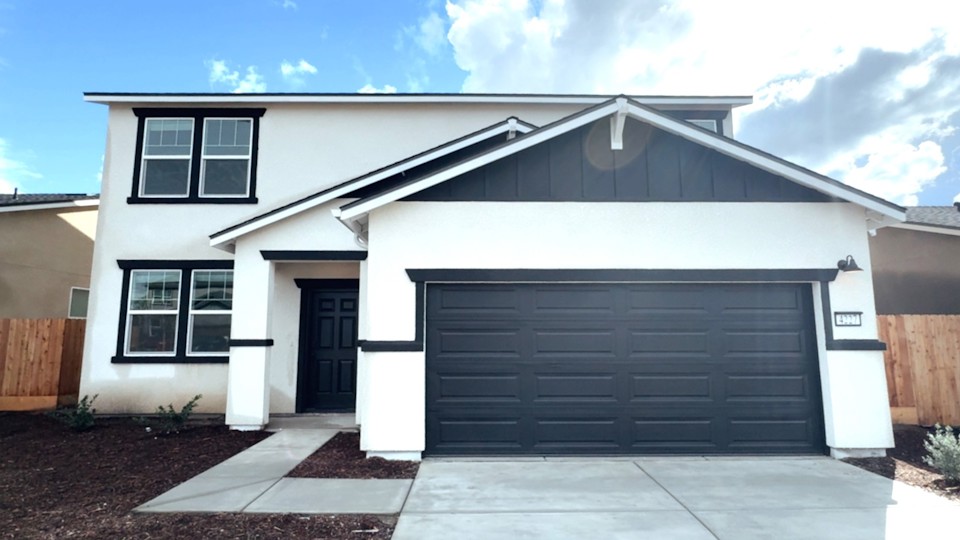 A white house with a garage.