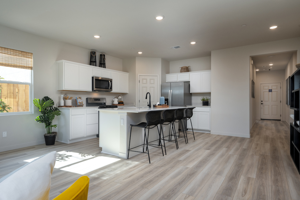 A kitchen with a wood floor.