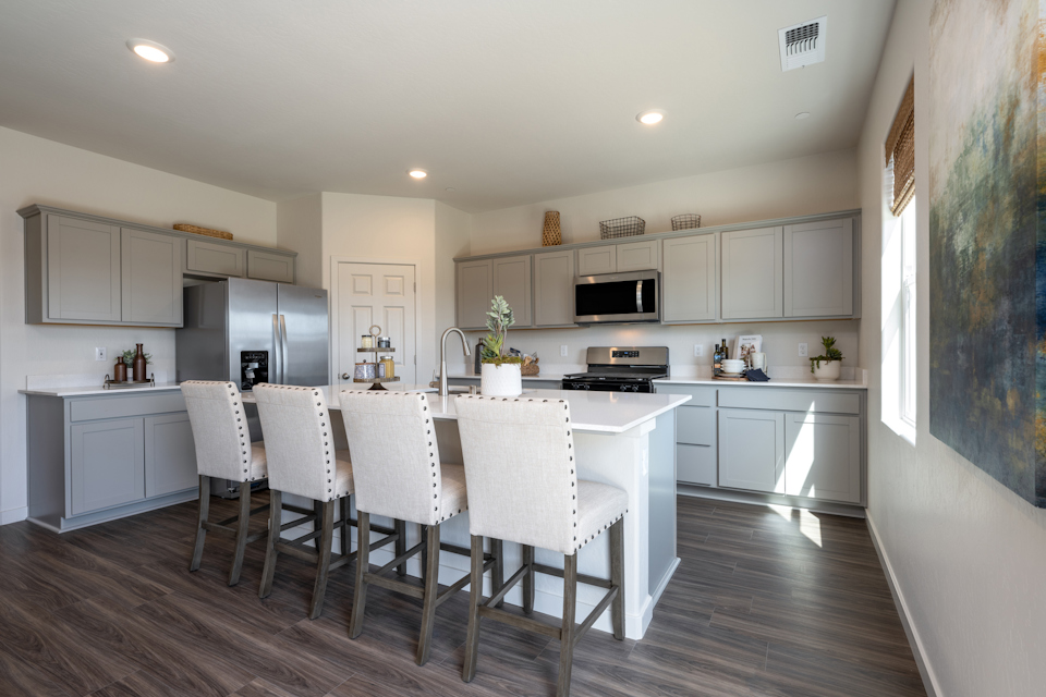 A kitchen with white cabinets.