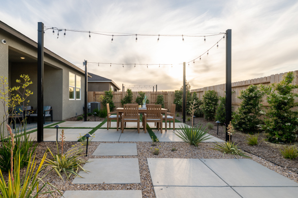 A patio with tables and chairs.