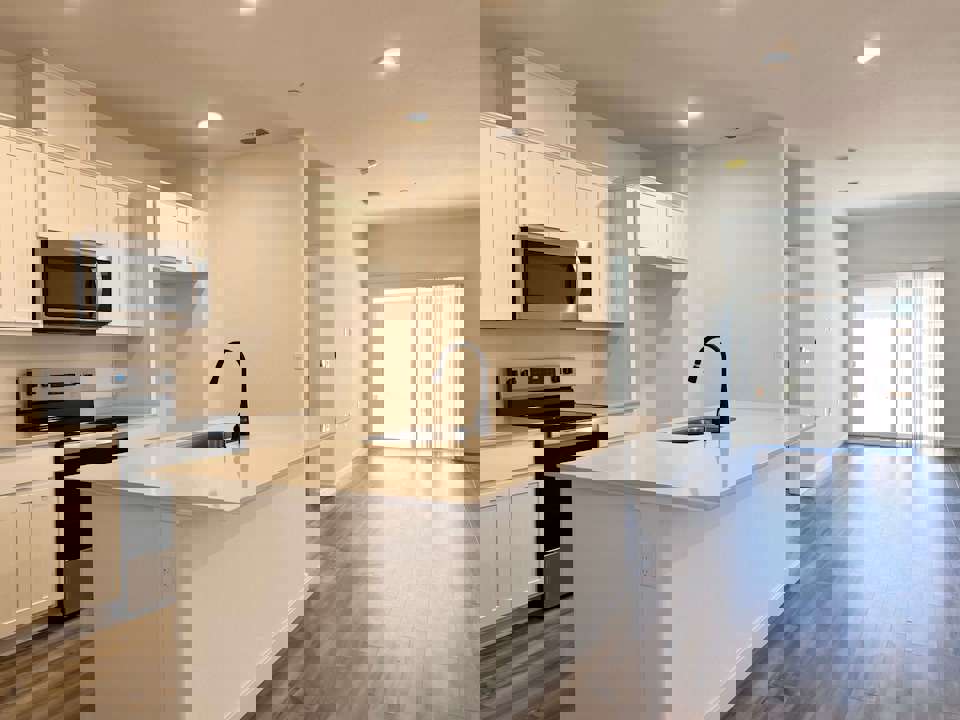 A kitchen with white cabinets.