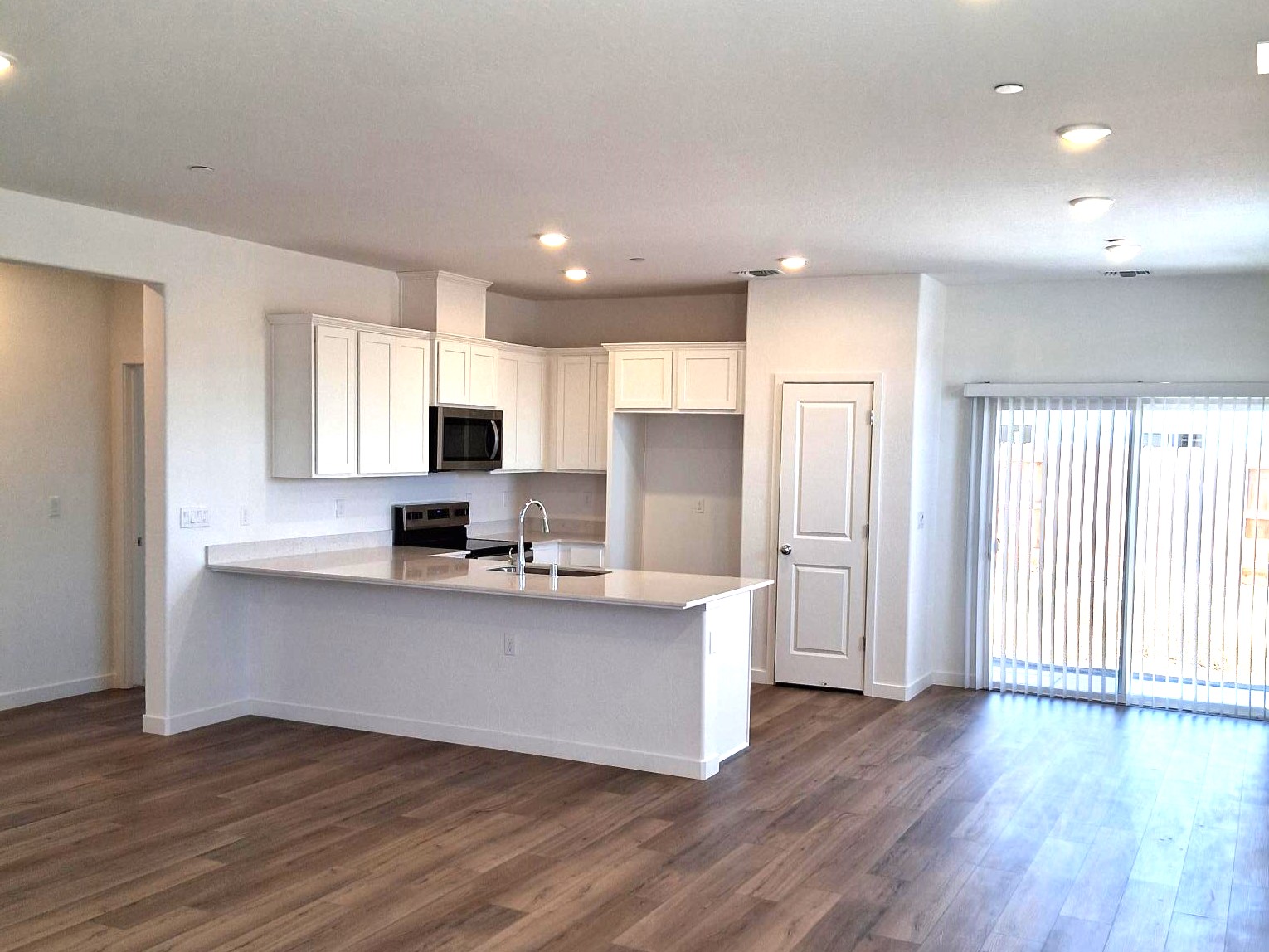 A kitchen with white cabinets.