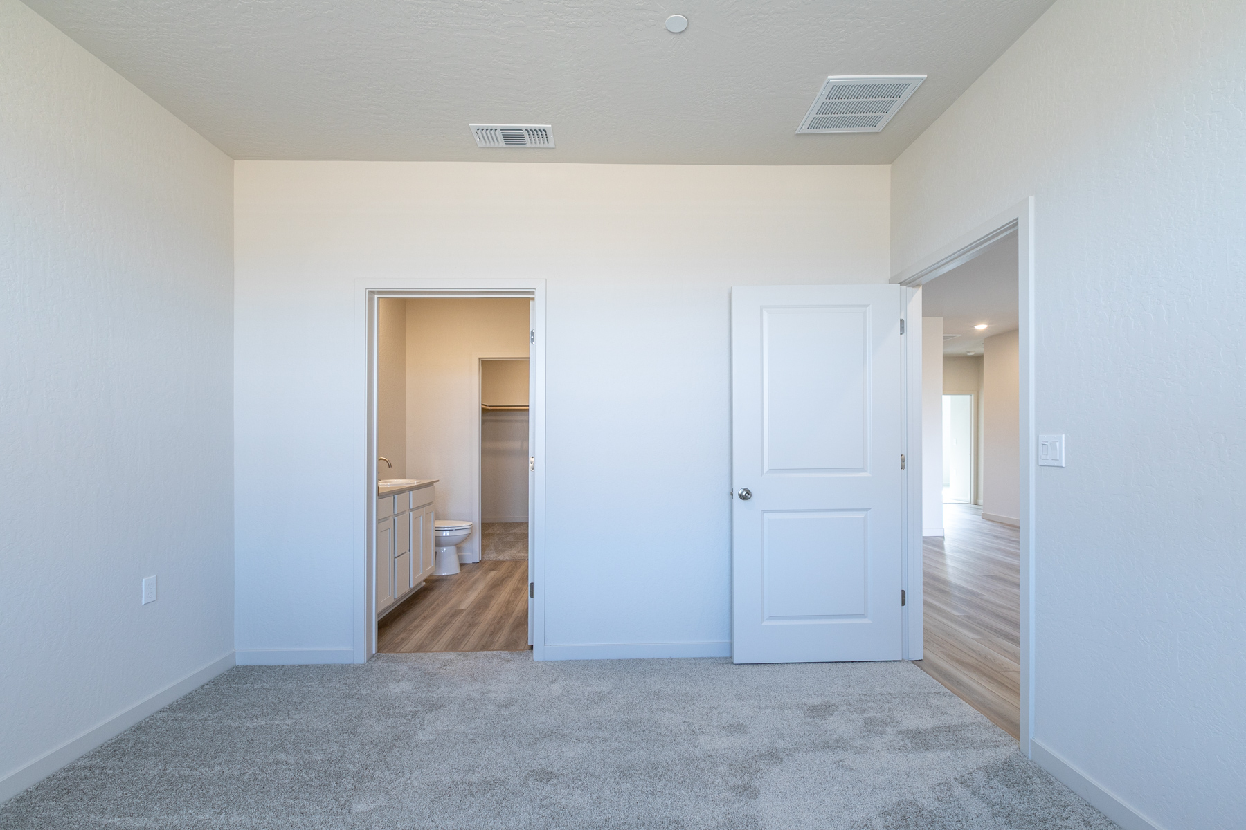 A hallway with white doors.