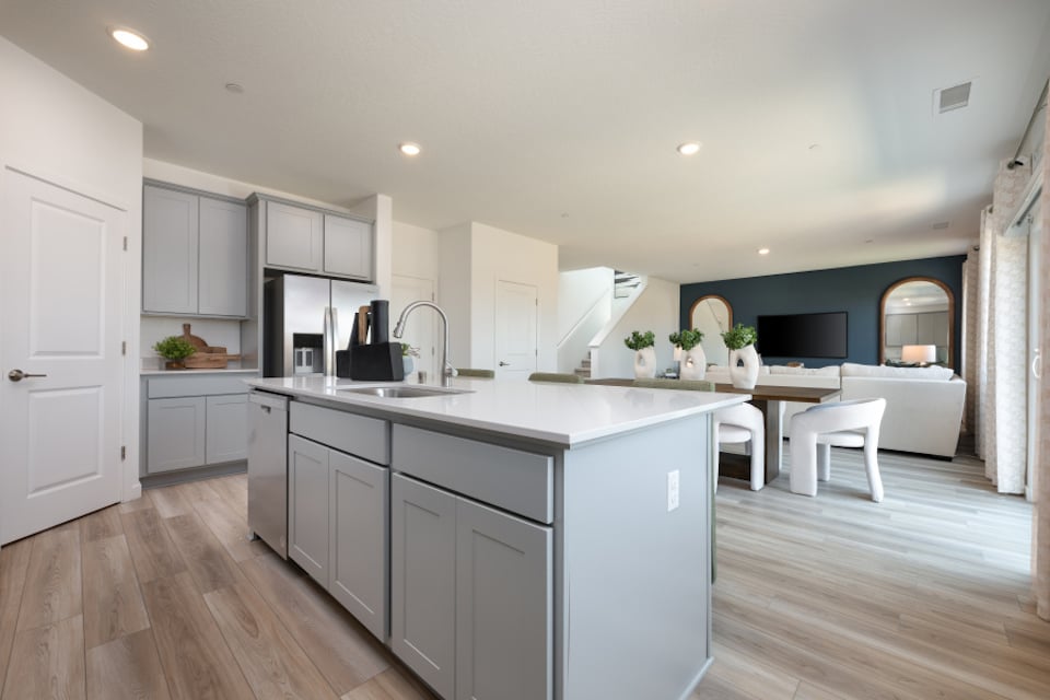 A kitchen with white cabinets.