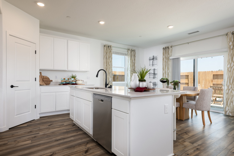 A kitchen with white cabinets.