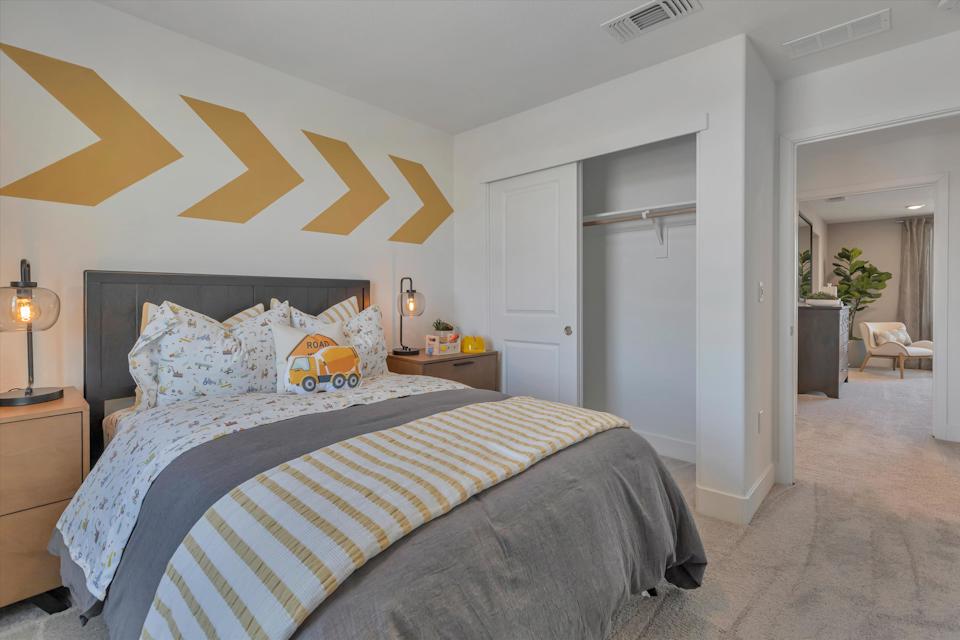 A bedroom with a bed and lamps.