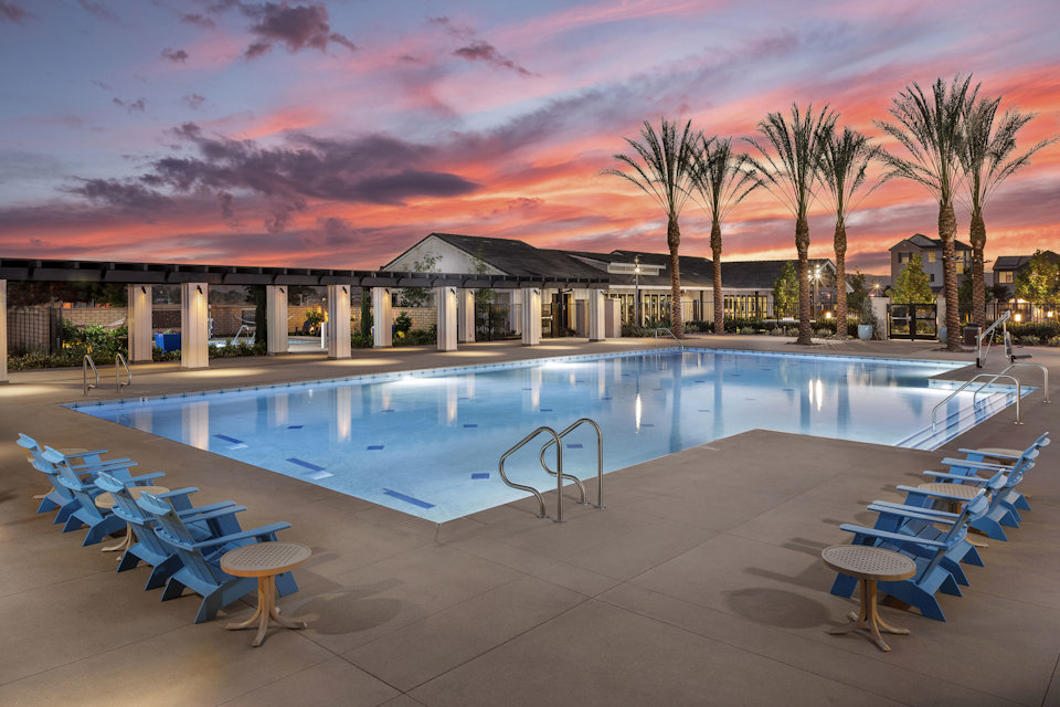 A pool with chairs around it.