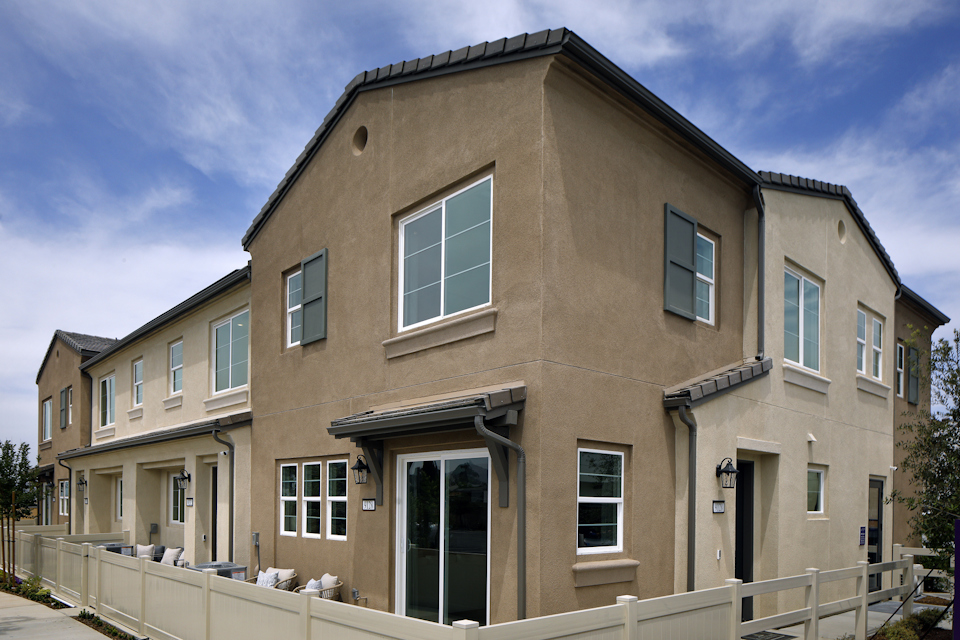 A large building with a white fence.