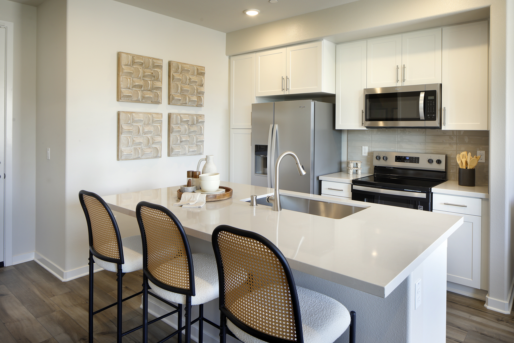 A kitchen with a table and chairs.