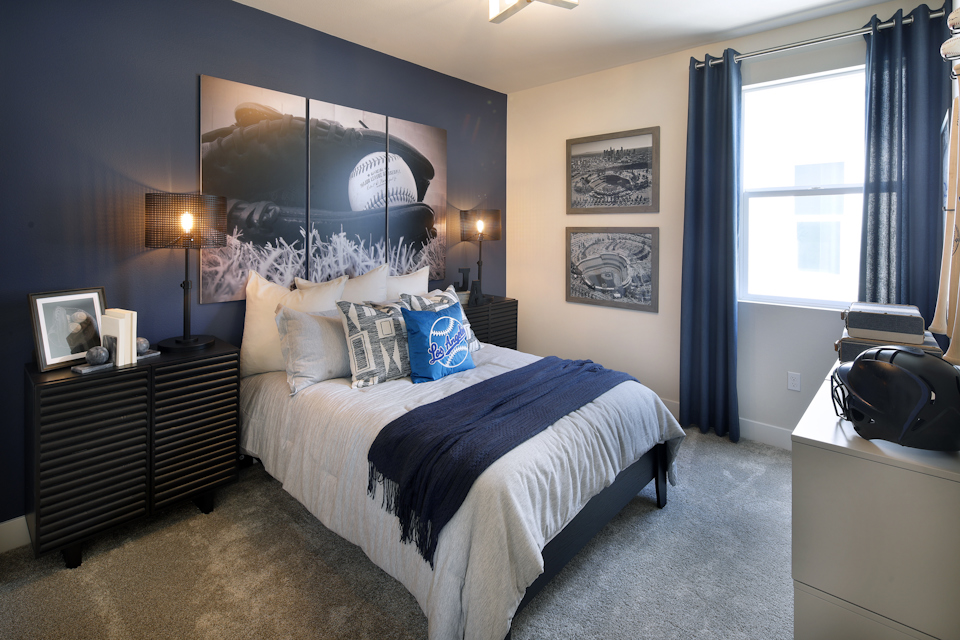 A bedroom with a large mirror.