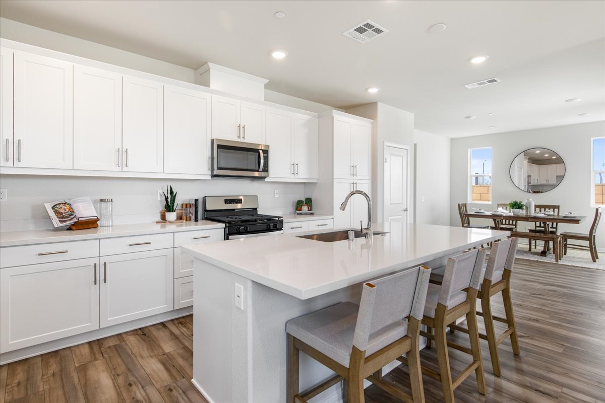 A kitchen with white cabinets.