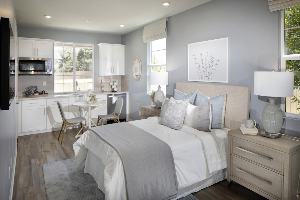 A bedroom with a bed and a table.