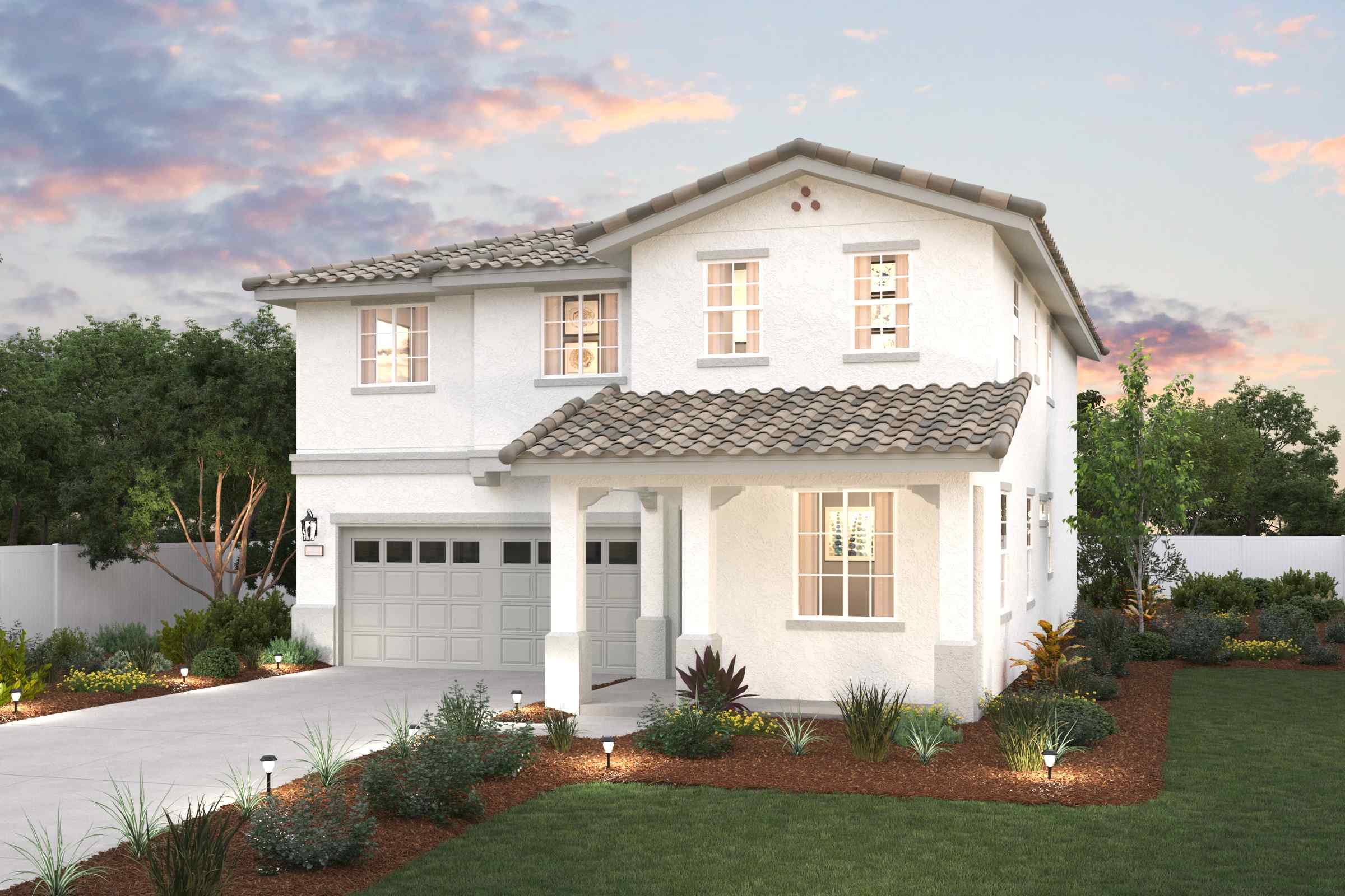 A white house with a green lawn.