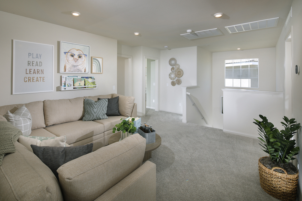 A living room with a couch and a rug.