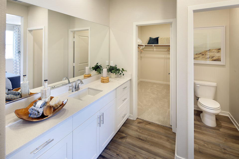 A bathroom with a tub sink and toilet.