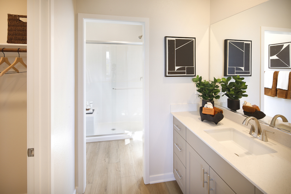 A bathroom with a sink and a shower.