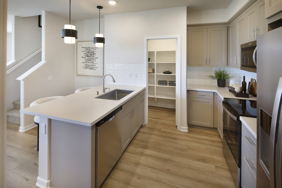 A kitchen with white cabinets.