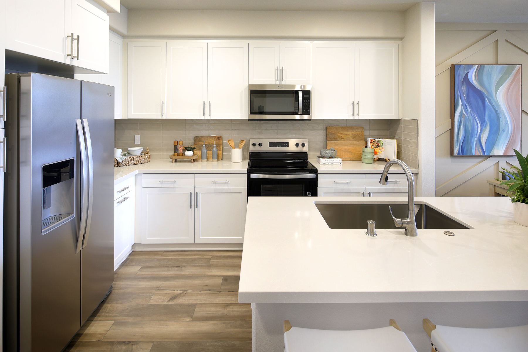 A kitchen with white cabinets.