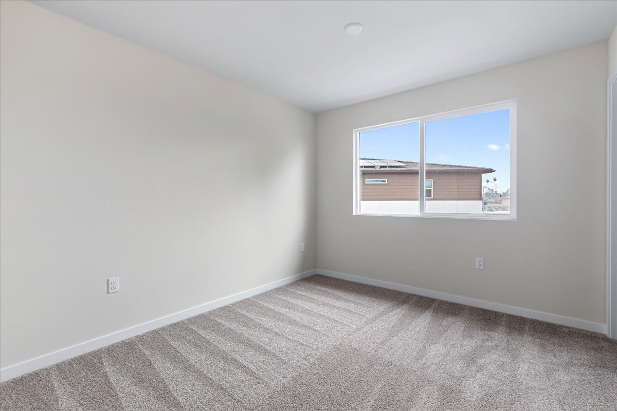 A room with a window and a carpet.