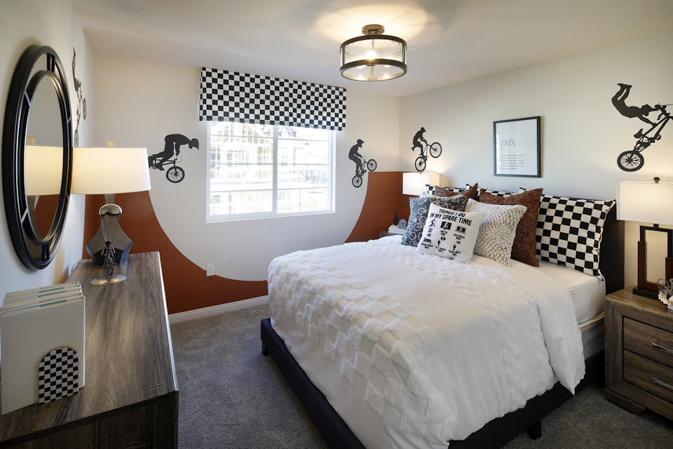 A bedroom with a bed and lamps.