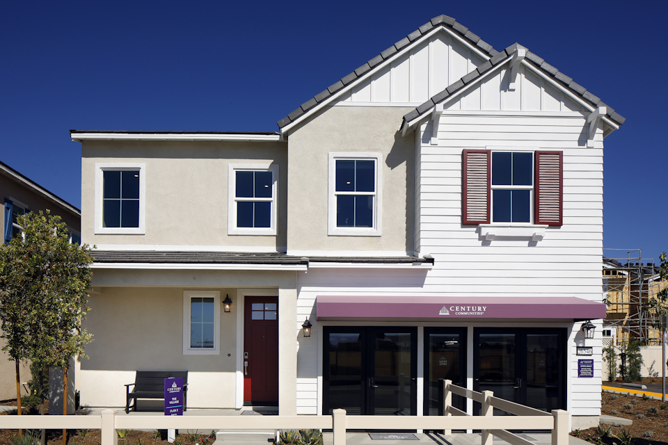 A white building with red shutters.