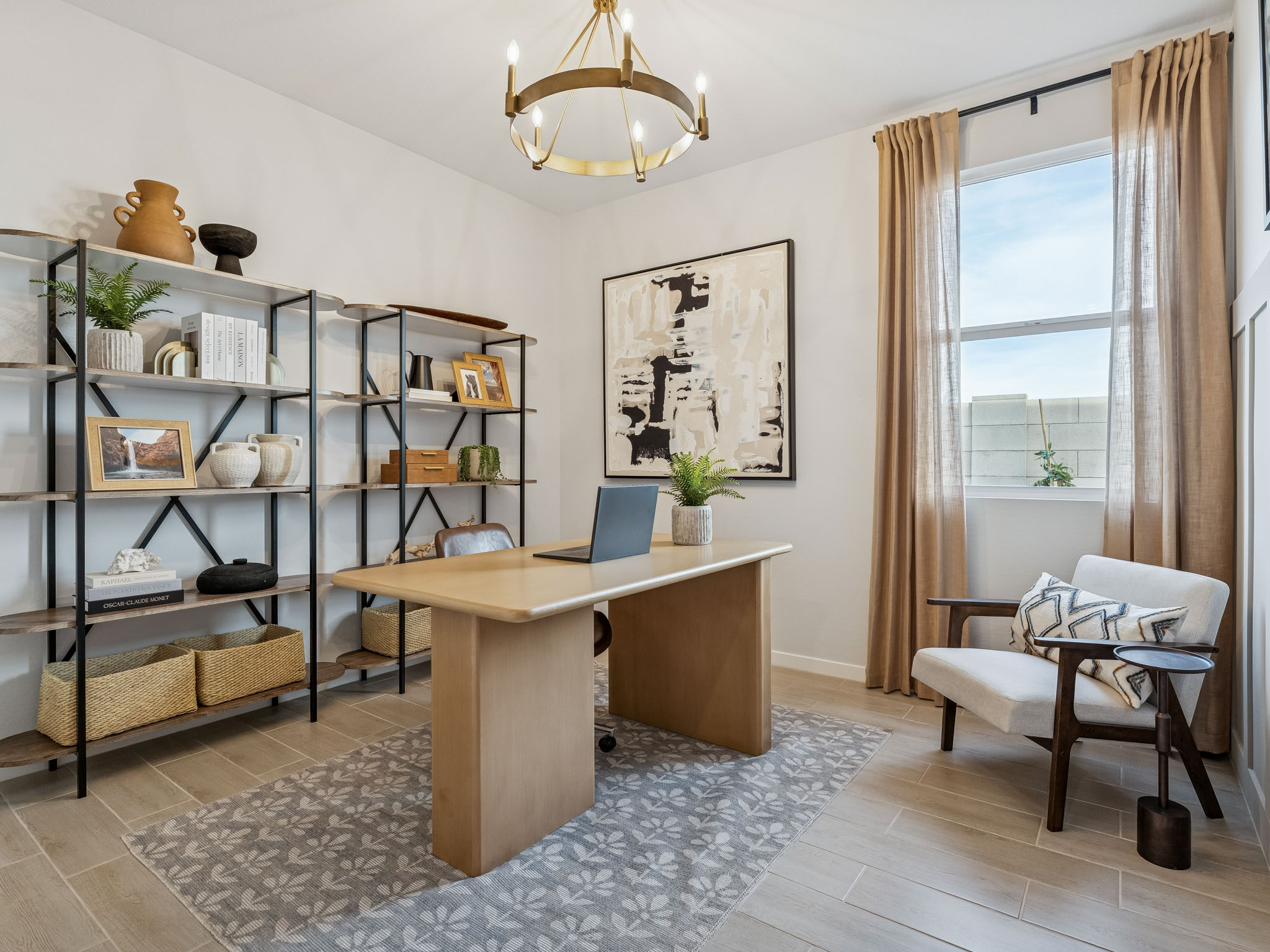 A room with a desk and shelves.