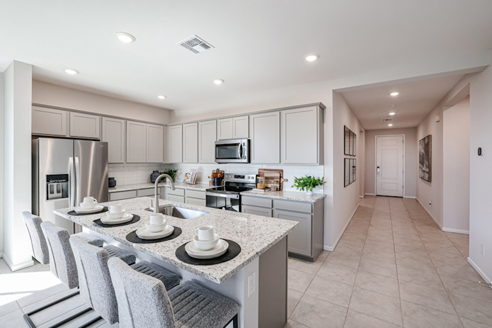 A kitchen with white cabinets.