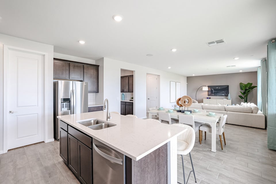 A kitchen with white furniture.