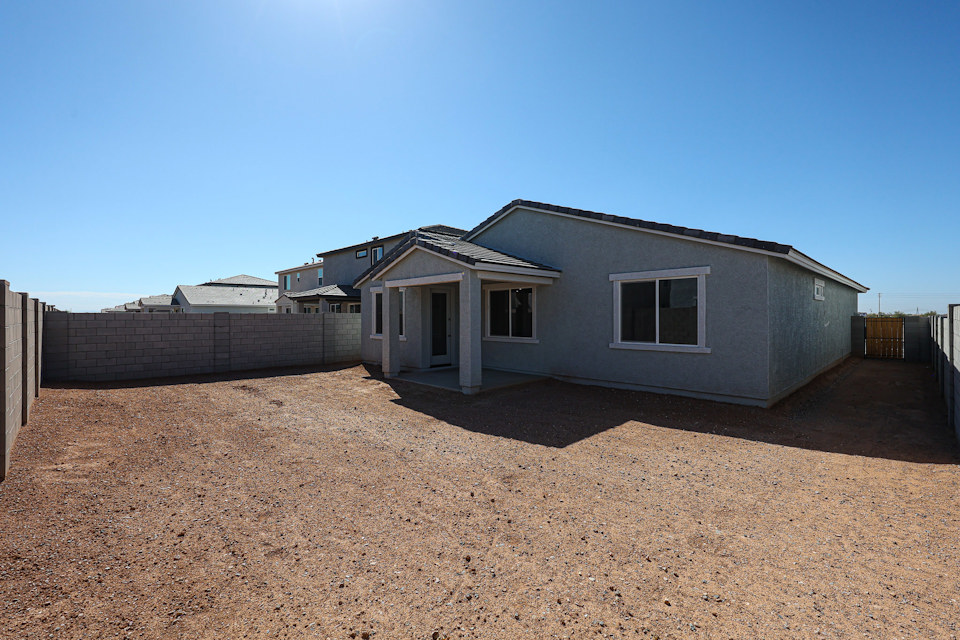 A house with a dirt yard.