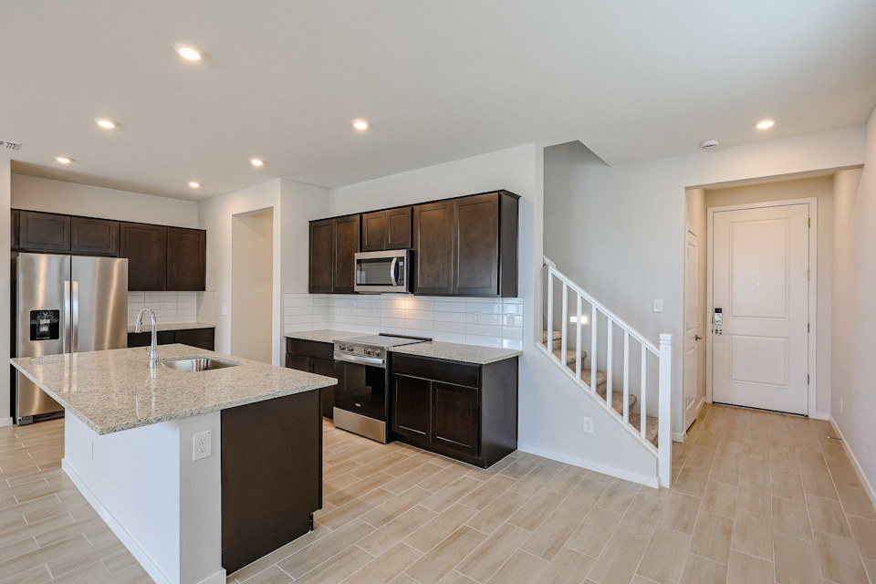 A kitchen with black cabinets.