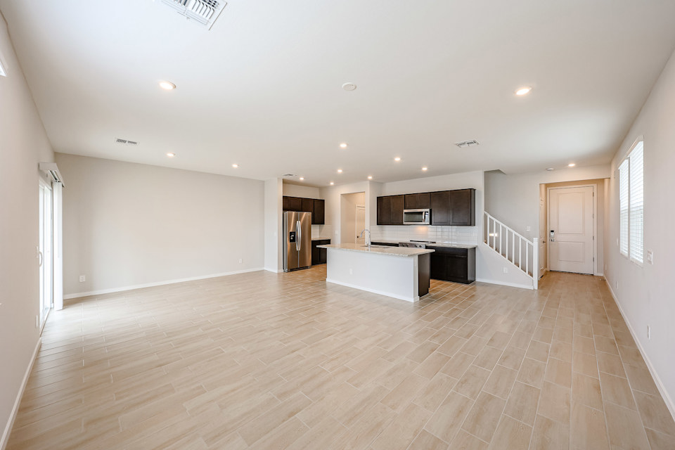 A large kitchen with wood floors.