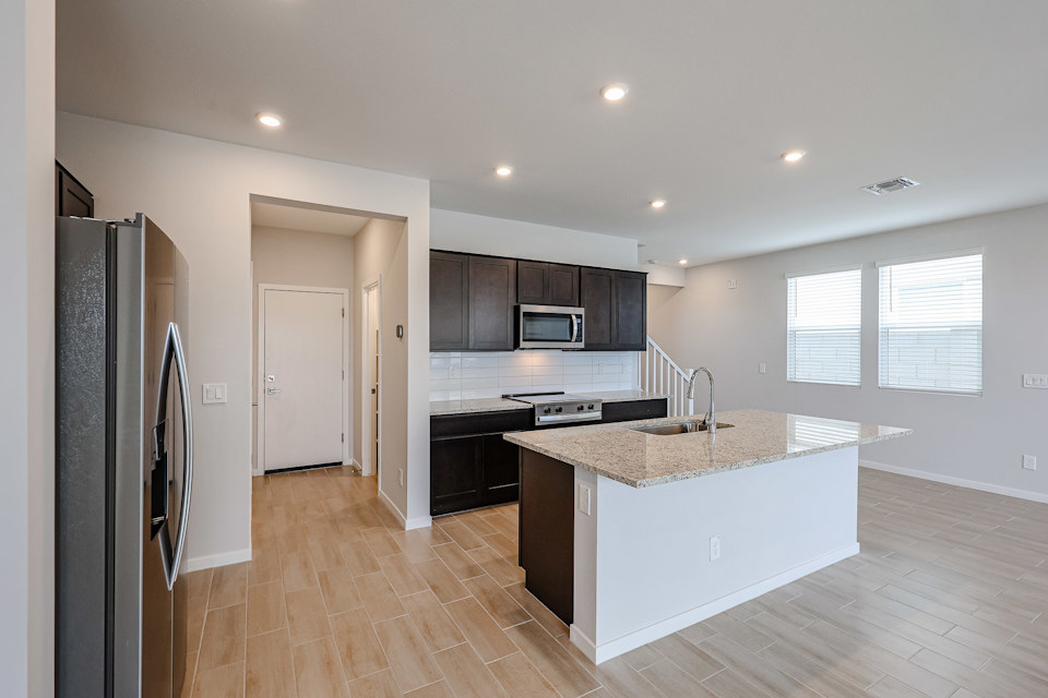 A kitchen with black cabinets.