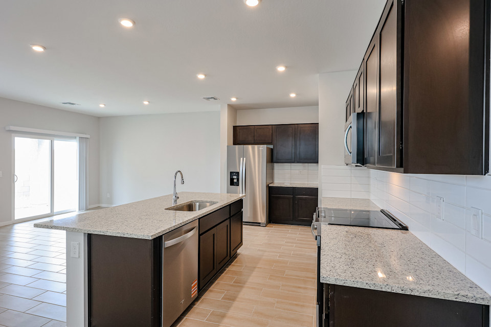 A kitchen with black cabinets.