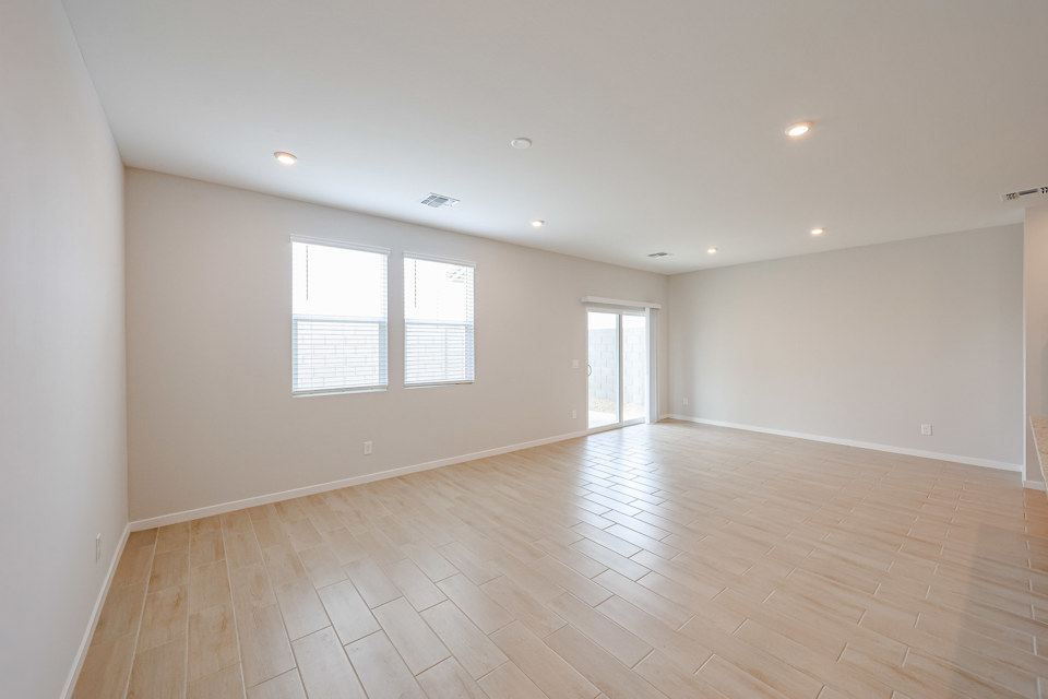 A room with a wood floor and windows.