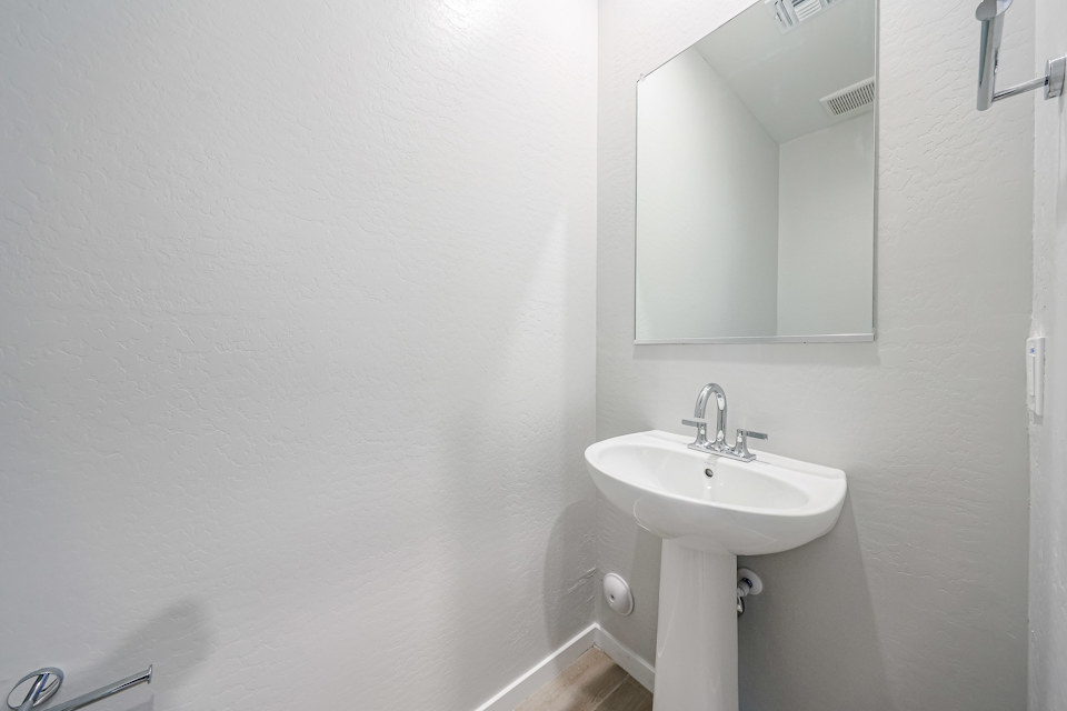 A bathroom with a mirror and sink.