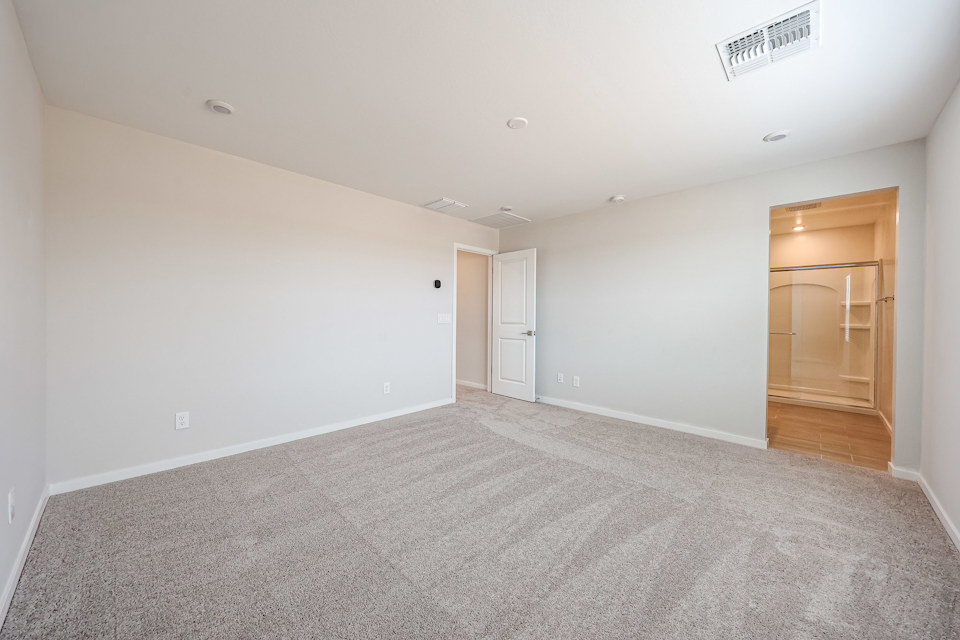 A room with white walls and a wood floor.