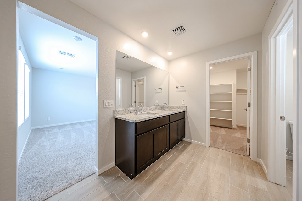 A bathroom with a large mirror.