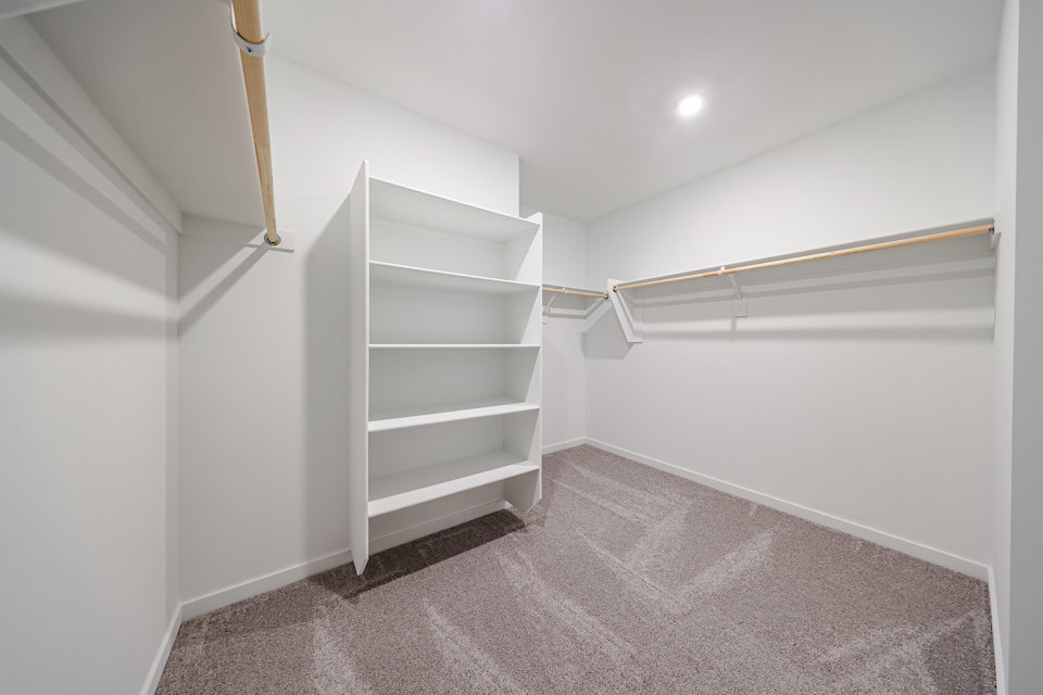 A white room with a white shelf.