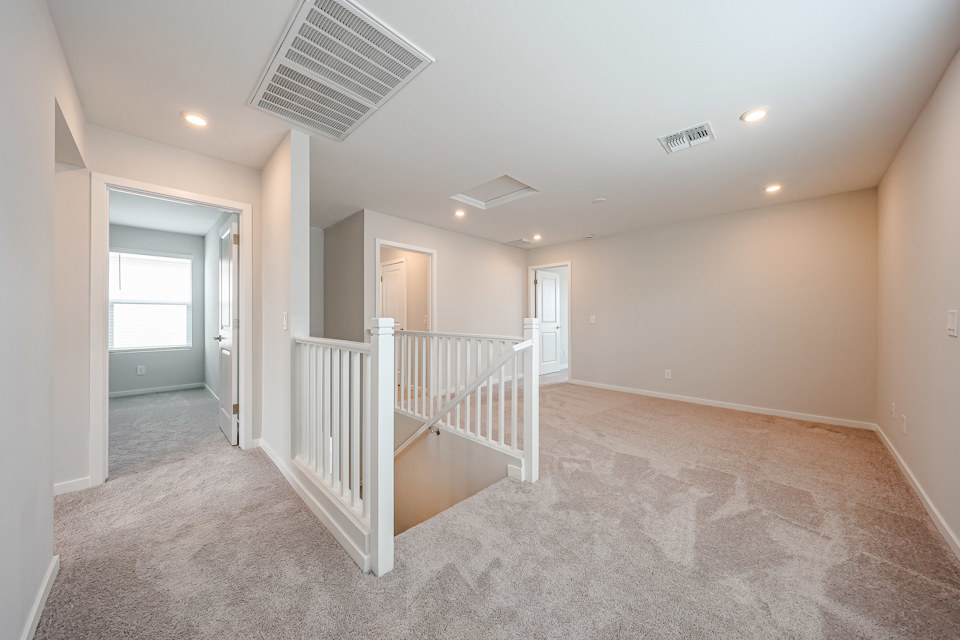 A room with a white railing and a white railing.