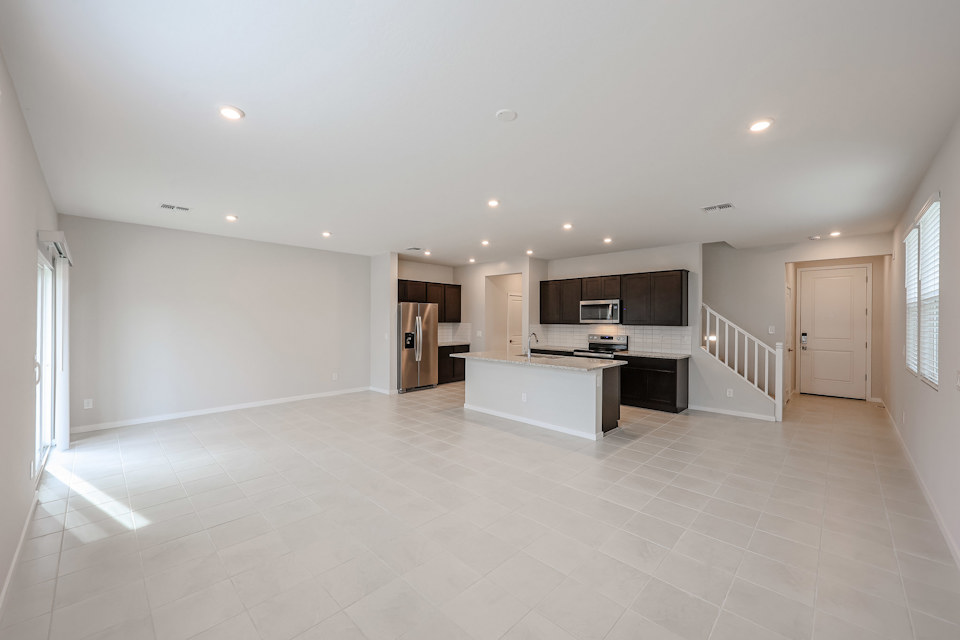 A large kitchen with white walls.