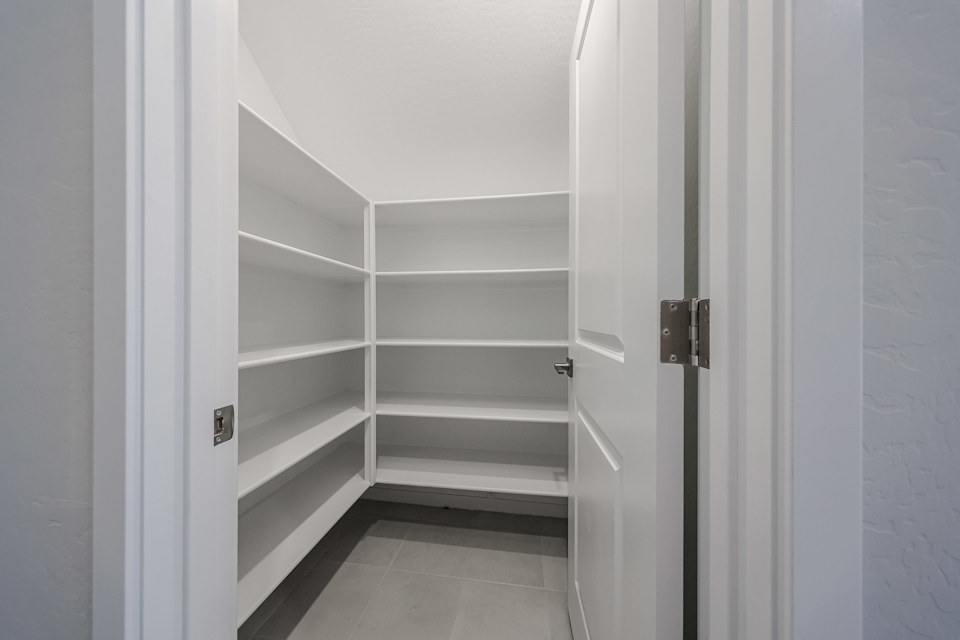 A white closet with white doors.