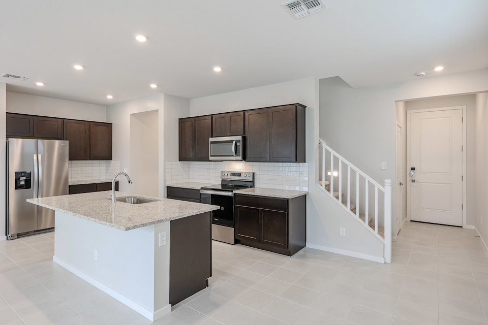 A kitchen with black cabinets.