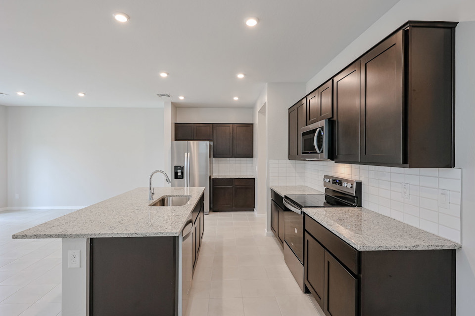 A kitchen with black cabinets.